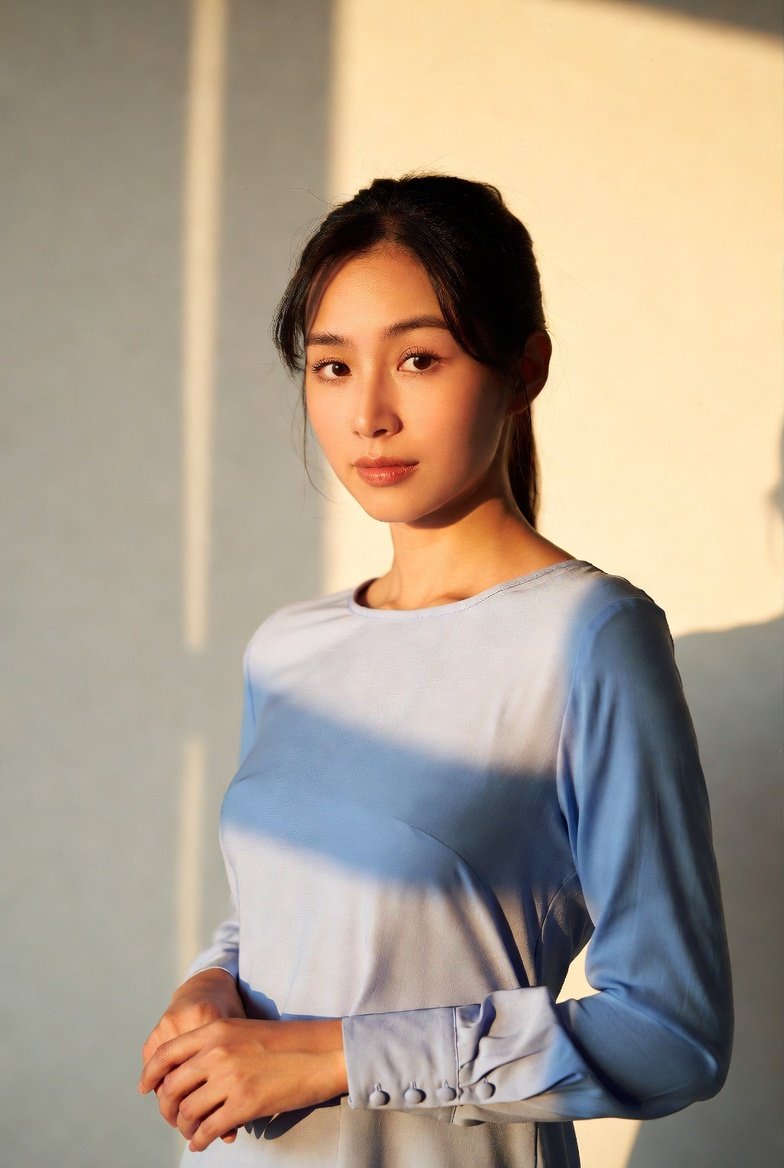 Model wearing a plain button-down shirt from the shirts and blouses range